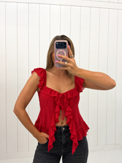 AI-assisted styled photo of Red Ruffle Detail Top on boutique owner, soft original-room lighting approved September 21 2026