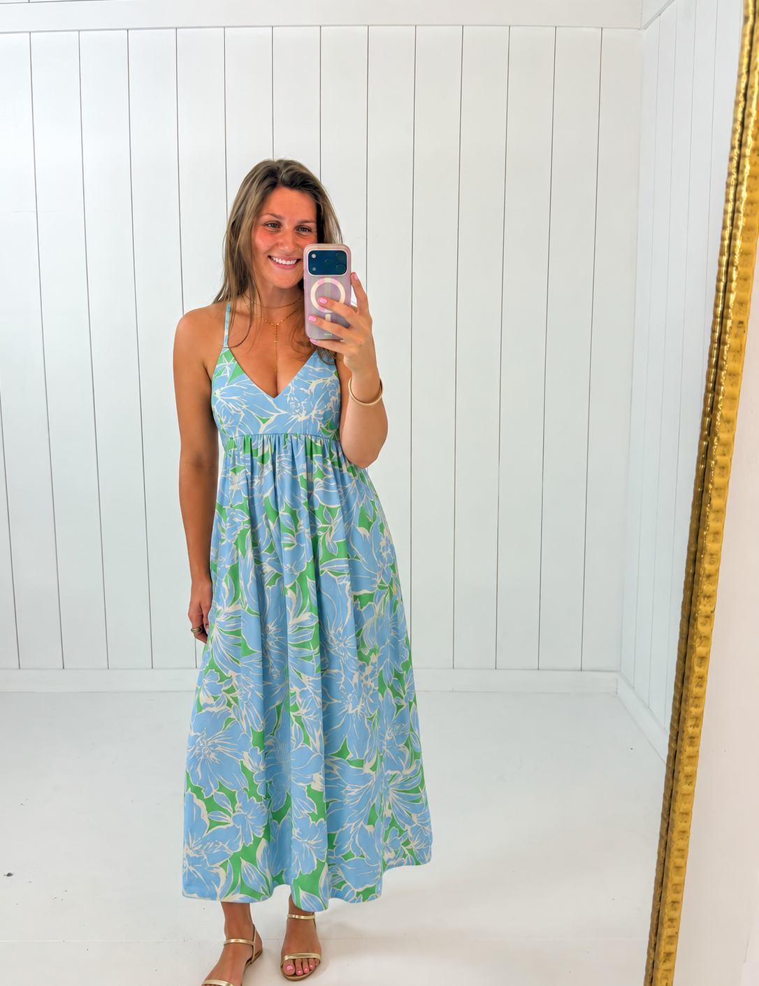 AI-assisted styled photo of Blue & Green Floral Maxi Dress on boutique owner, soft original-room lighting approved September 21 2026