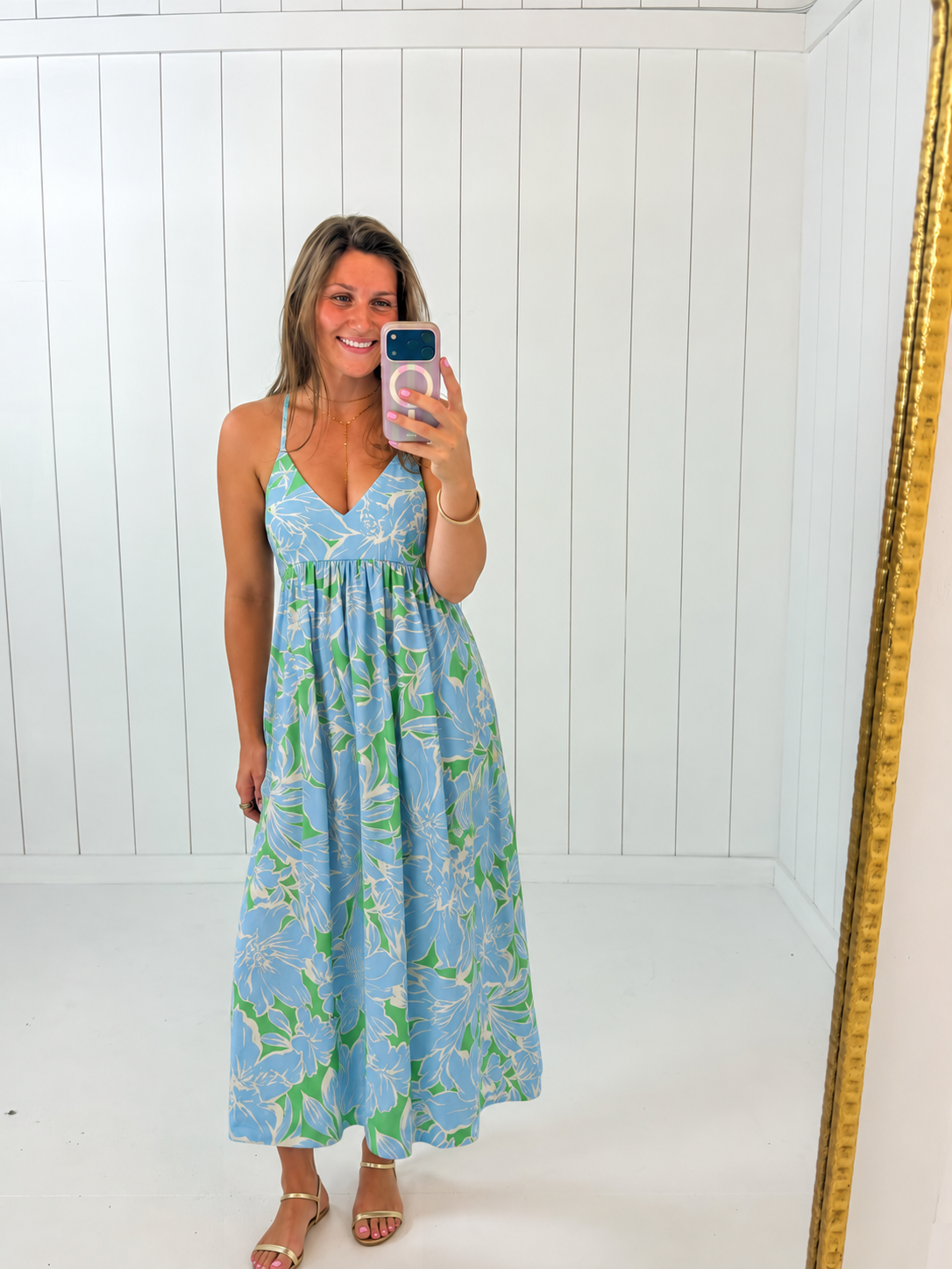 AI-assisted styled photo of Blue & Green Floral Maxi Dress on boutique owner, soft original-room lighting approved September 21 2026