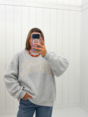 AI-assisted styled photo of Grey Jesus Camo Mockneck on boutique owner, soft original-room lighting approved September 21 2026