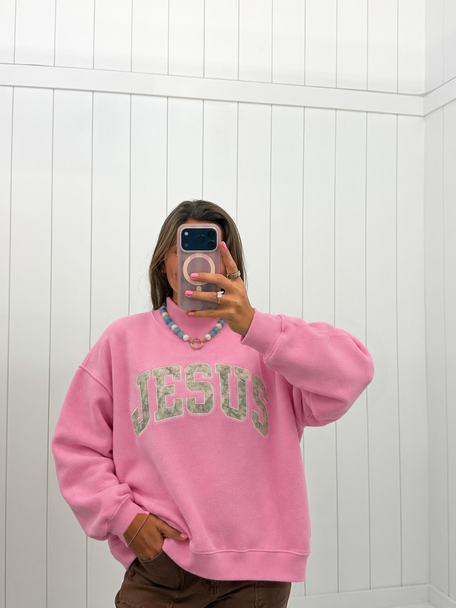 AI-assisted styled photo of Pink Jesus Camo Mockneck on boutique owner, soft original-room lighting approved September 21 2026