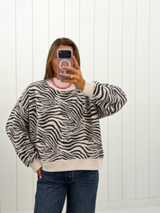 AI-assisted styled photo of Zebra Mockneck Sweatshirt on boutique owner, soft original-room lighting approved September 21 2026