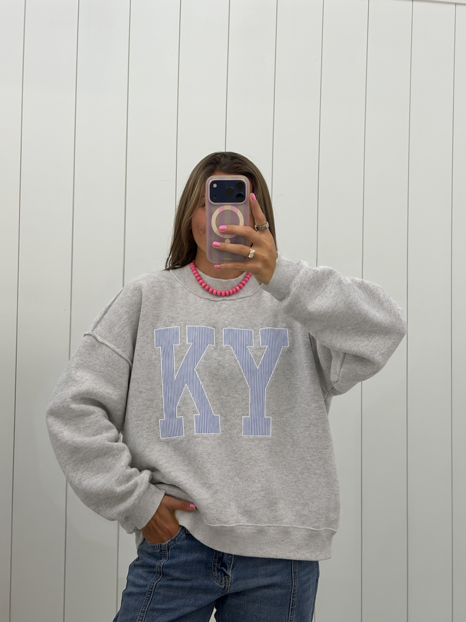AI-assisted styled photo of Gray KY Stripe Mockneck on boutique owner, soft original-room lighting approved September 21 2026