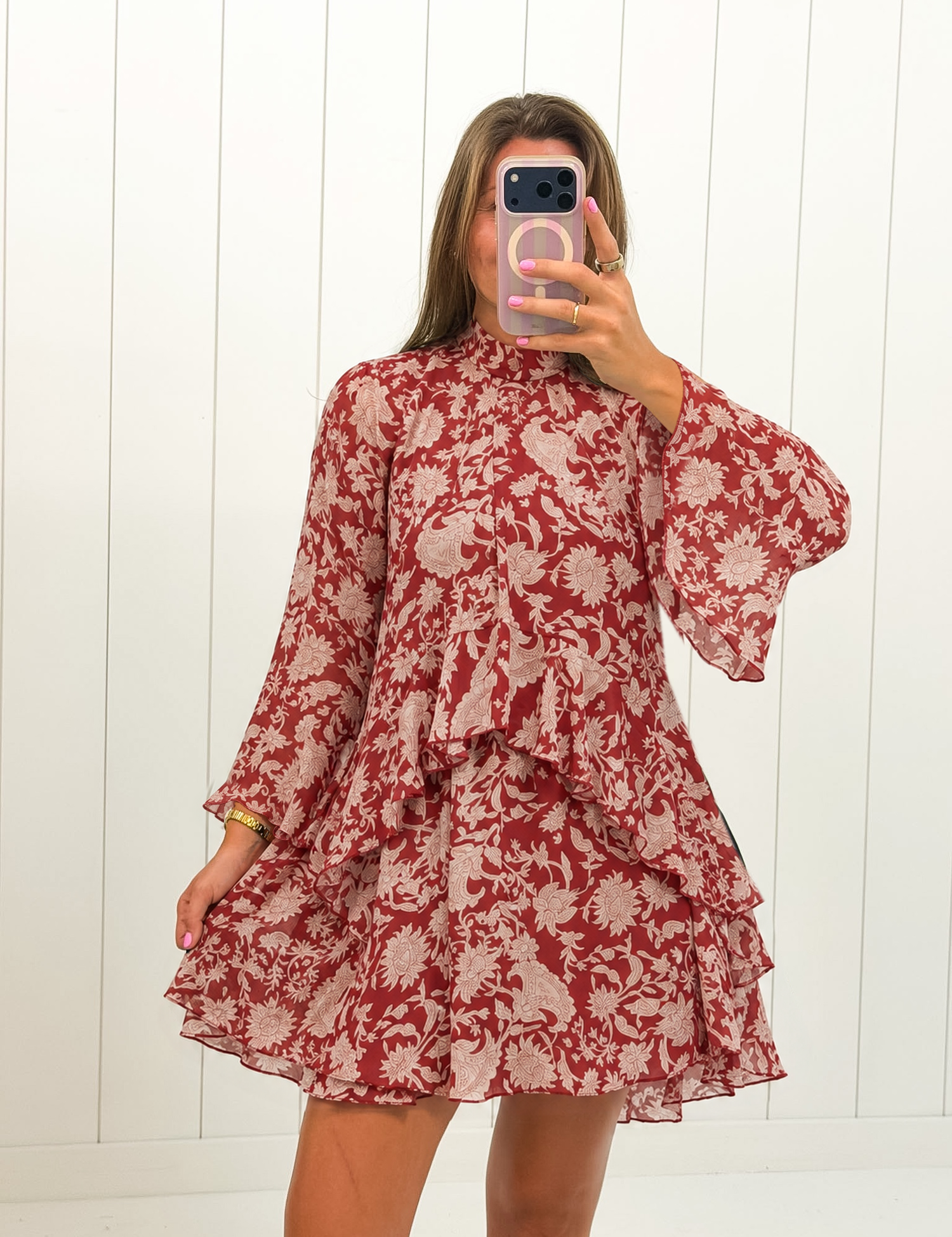 AI-assisted styled photo of Red Floral Neck Tie Mini Dress on boutique owner, soft original-room lighting approved September 21 2026