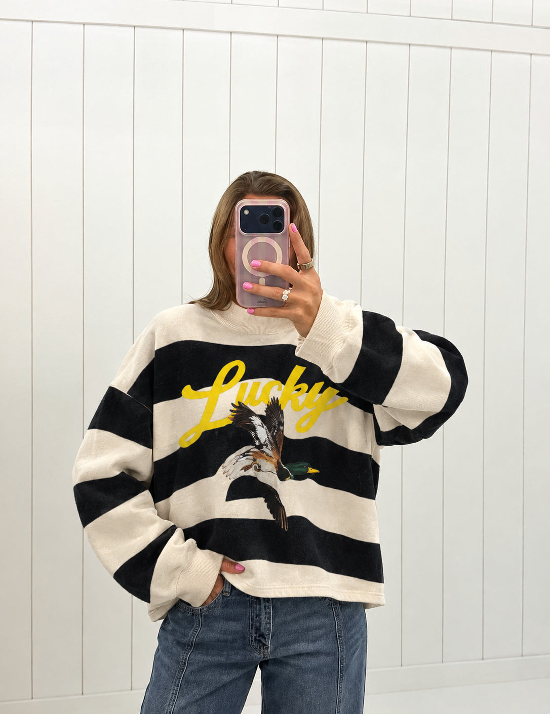 AI-assisted virtual try-on of Black Lucky & Mallard Mockneck on boutique owner. Approved October 4, 2026; no-feet crop.