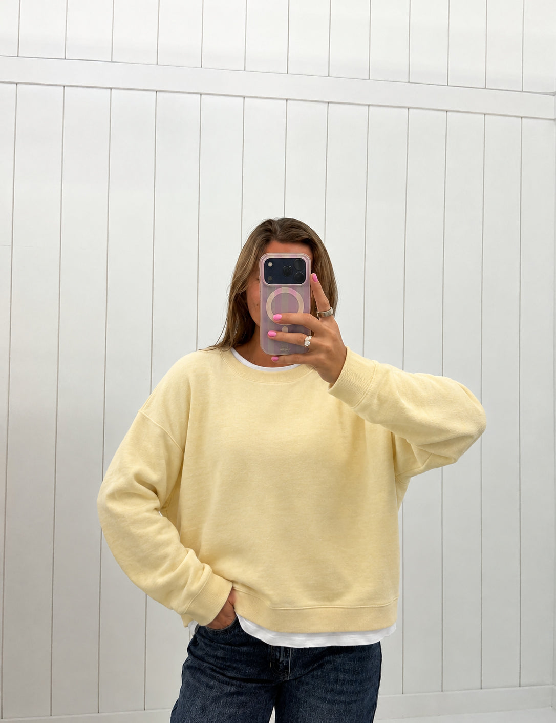 AI-assisted virtual try-on of Yellow Layered Crew Pullover on boutique owner. Approved October 4, 2026; no-feet crop.