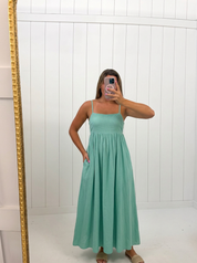 AI-assisted FASHN try-on of Mint Open Back Tie Strap Maxi Dress on boutique owner.