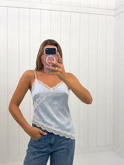 AI-assisted FASHN try-on of Blue Asymmetrical Satin Cami on boutique owner.