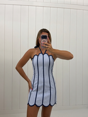AI-assisted FASHN try-on of Blue Contrast Piping Halter Neck Mini Dress on boutique owner. Revised standing pose September 27 2026.