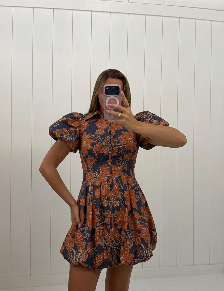 AI-assisted FASHN try-on of Navy & Orange Floral Bubble Mini Dress on boutique owner.