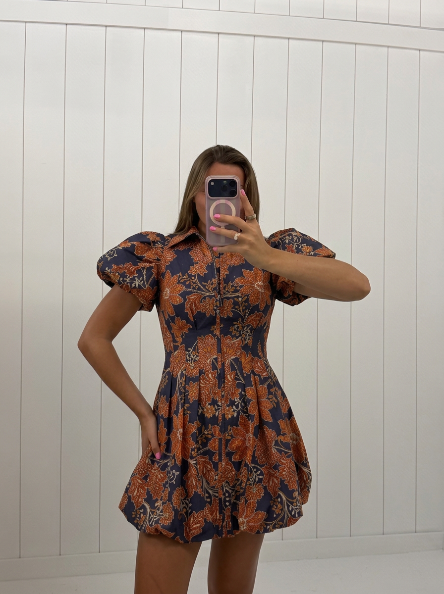 AI-assisted FASHN try-on of Navy &amp; Orange Floral Bubble Mini Dress on boutique owner.
