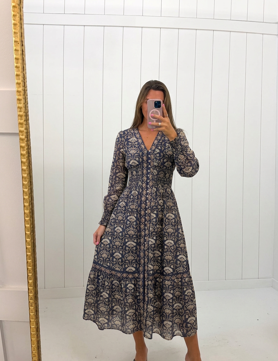 AI-assisted FASHN try-on of Navy Floral Smocked Waist Midi Dress on boutique owner.