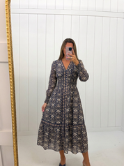 AI-assisted FASHN try-on of Navy Floral Smocked Waist Midi Dress on boutique owner.