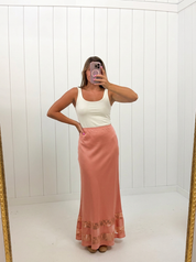AI-assisted FASHN try-on of Coral Satin Lace Maxi Skirt on boutique owner.