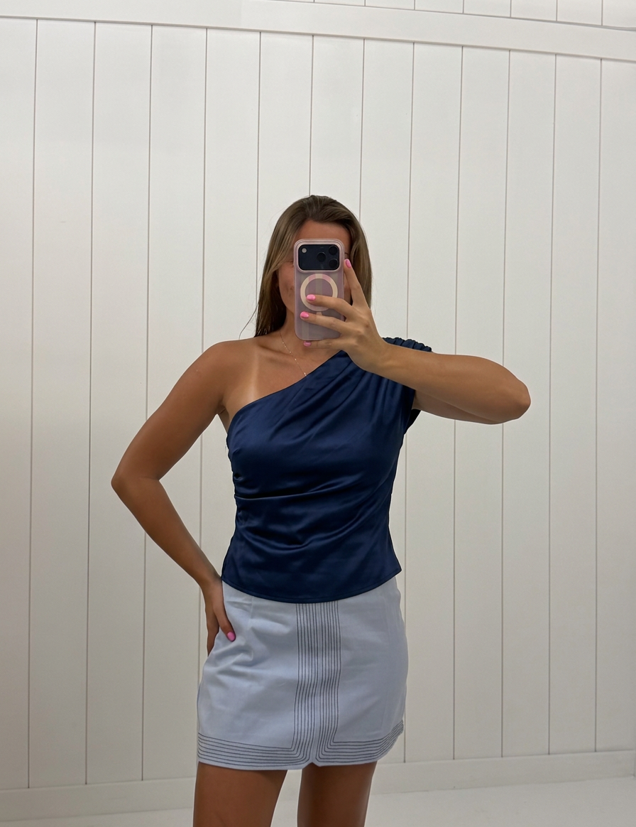 AI-assisted FASHN try-on of Navy Satin Asymmetrical Top on boutique owner.