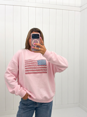 AI-assisted FASHN try-on of Pink Crewneck USA Flag Art Work on boutique owner.