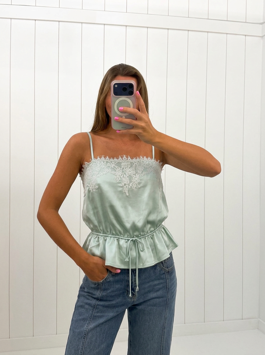 AI-assisted FASHN try-on of Mint Satin Peplum Top on boutique owner.