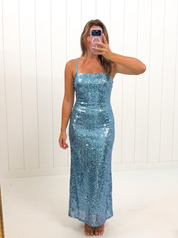 AI-assisted FASHN try-on of Blue Sequin Maxi Dress on boutique owner.