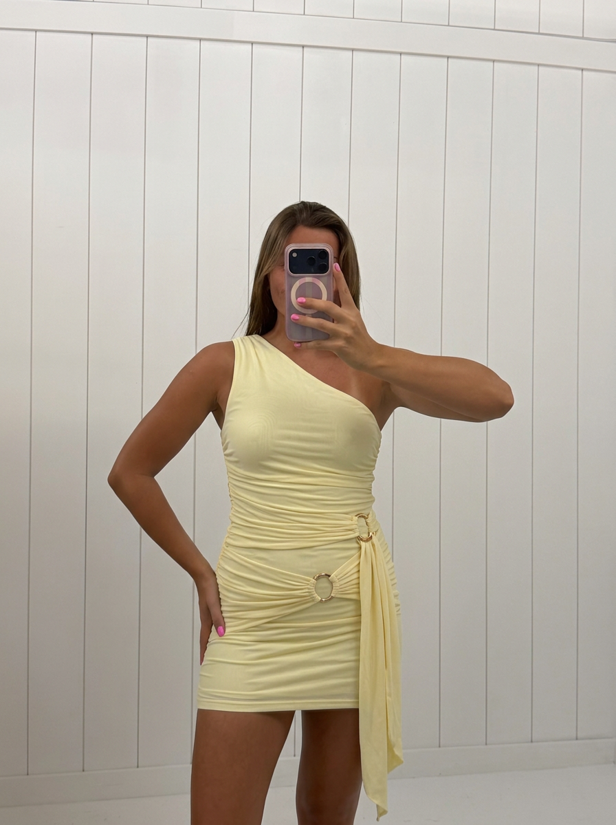 AI-assisted FASHN try-on of Yellow Ruched Mini Dress on boutique owner.