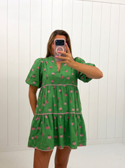 AI-assisted FASHN try-on of Green Tiered Floral Mini Dress on boutique owner.