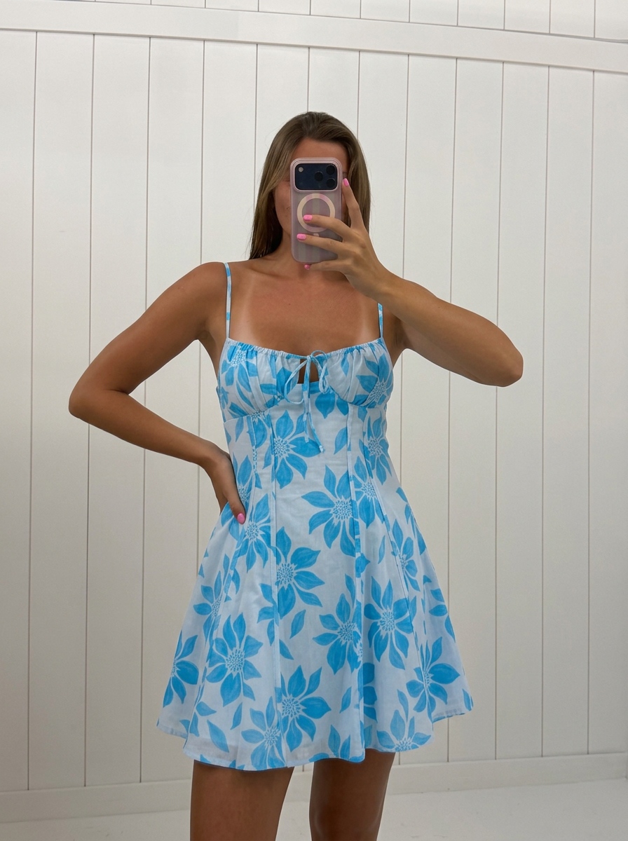 AI-assisted FASHN try-on of Light Blue Floral Mini Dress on boutique owner.