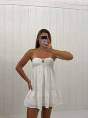 AI-assisted FASHN try-on of White Lace Babydoll Mini Dress on boutique owner.