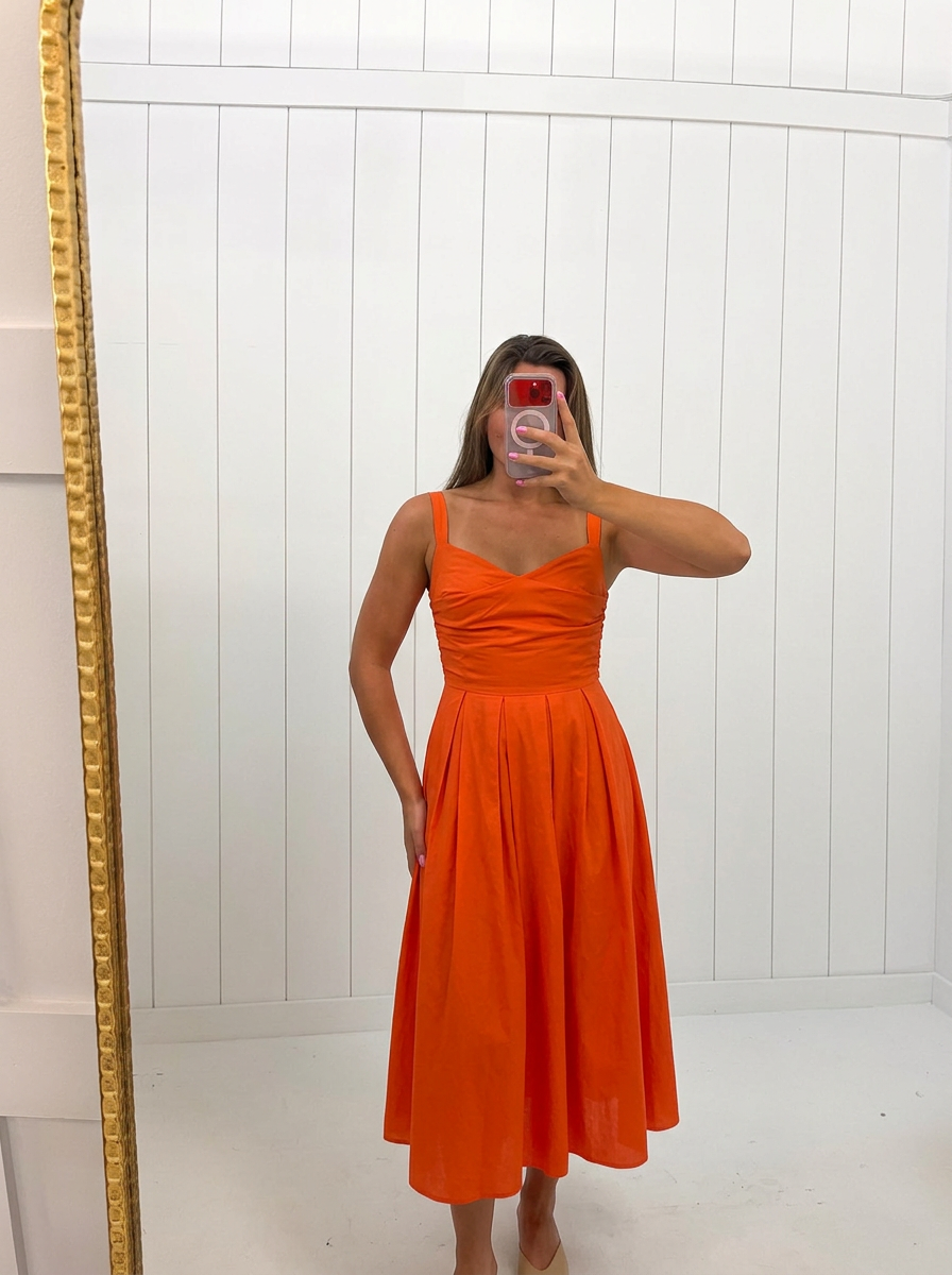 AI-assisted FASHN try-on of Red Valerie Fit And Flare Dress on boutique owner.