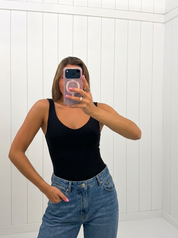 AI-assisted FASHN try-on of Black Bodysuit on boutique owner.
