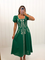 AI-assisted FASHN try-on of Green Embroidered Puff Sleeve Midi Dress on boutique owner.