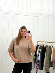 AI-assisted FASHN try-on of Brown Knit Sweater on boutique owner.