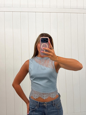 AI-assisted FASHN try-on of Blue Lace Sleeveless Top on boutique owner.