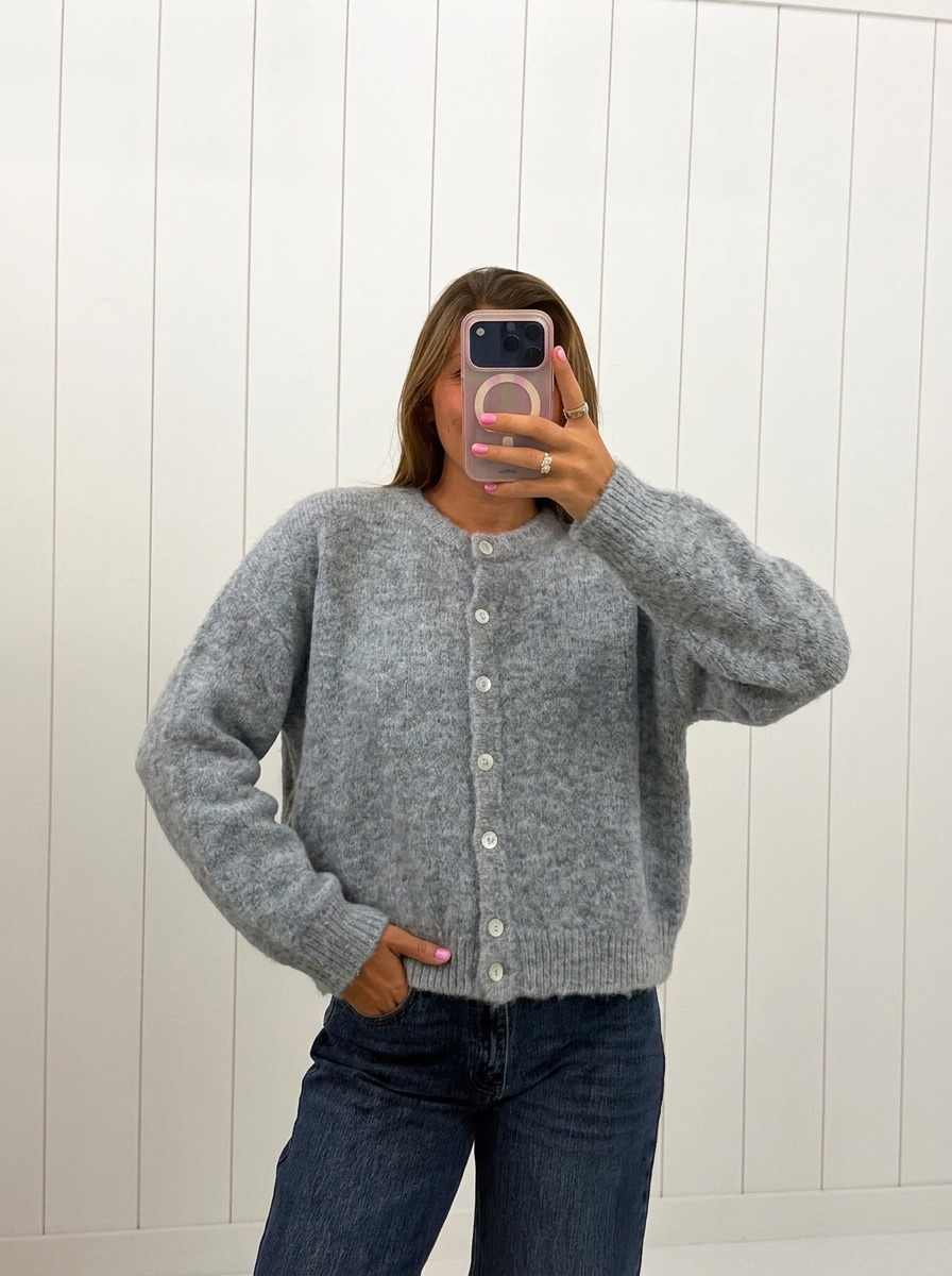 AI-assisted FASHN try-on of Gray Lucas Cardigan on boutique owner.