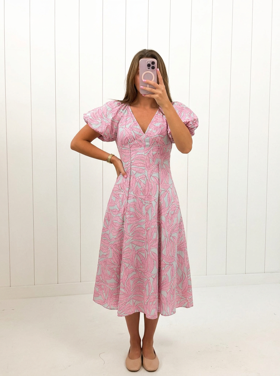 AI-assisted FASHN try-on of Pink Tropical Puff Sleeve Midi Dress on boutique owner.