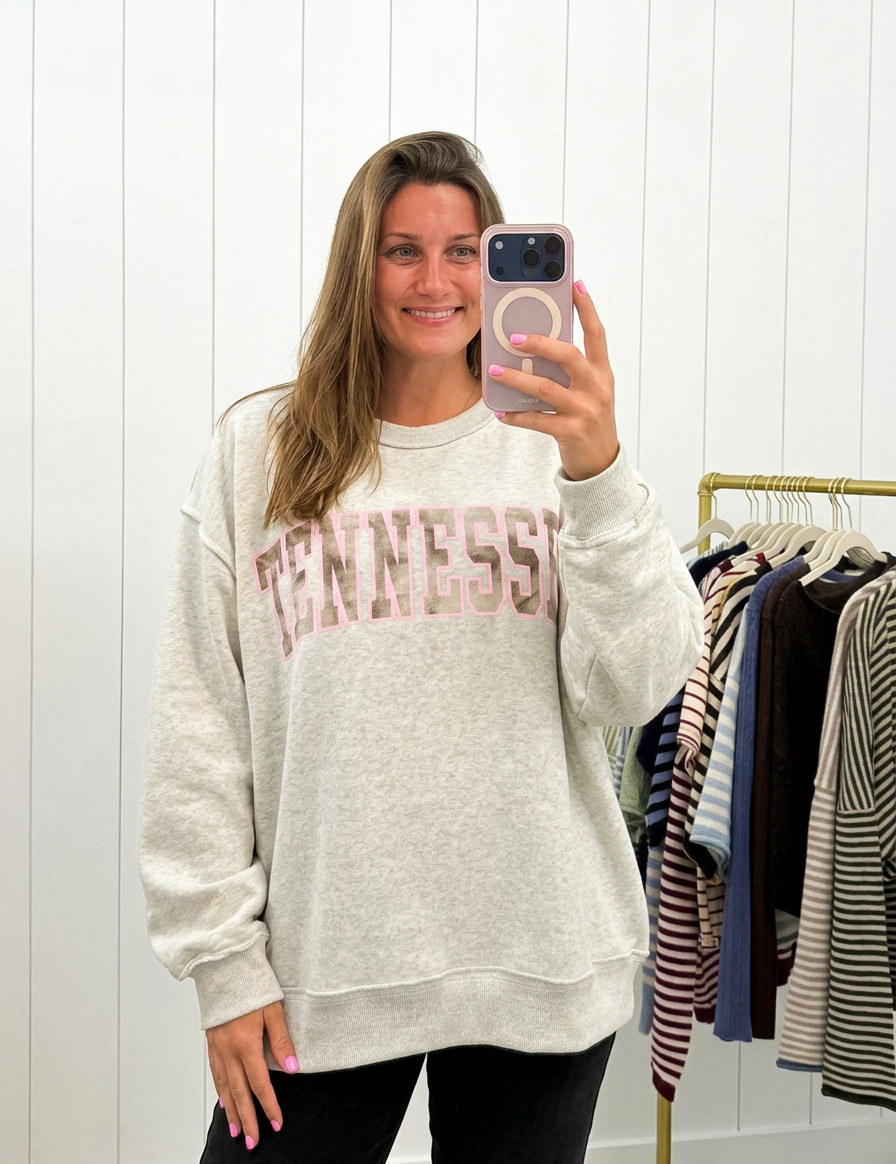 AI-assisted FASHN try-on of Grey & Camo Tennessee Crewneck on boutique owner.