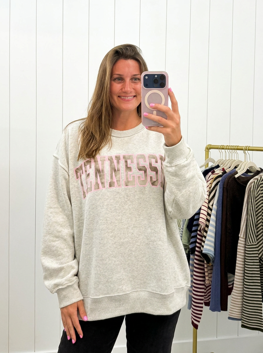 AI-assisted FASHN try-on of Grey &amp; Camo Tennessee Crewneck on boutique owner.