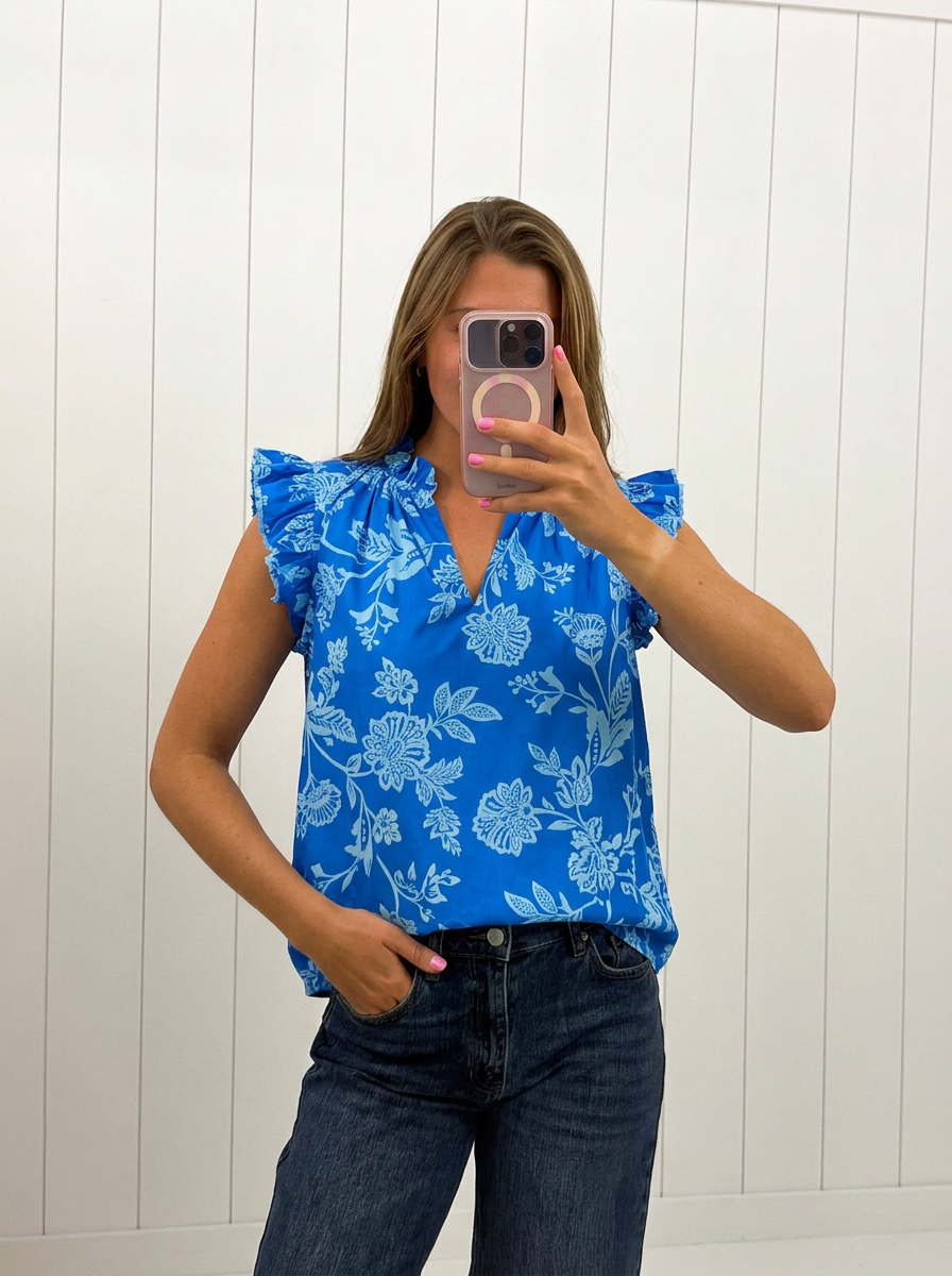 AI-assisted FASHN try-on of Blue Ruffle Floral Top on boutique owner.