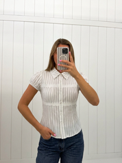 AI-assisted FASHN try-on of White & Black Stripe Collared Top on boutique owner.