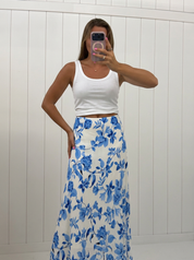 AI-assisted FASHN try-on of Blue Floral Flow Maxi Skirt on boutique owner.