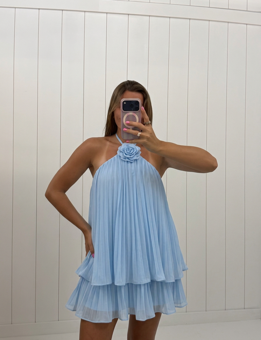 AI-assisted FASHN try-on of Light Blue Flower Pin Mini Dress on boutique owner.