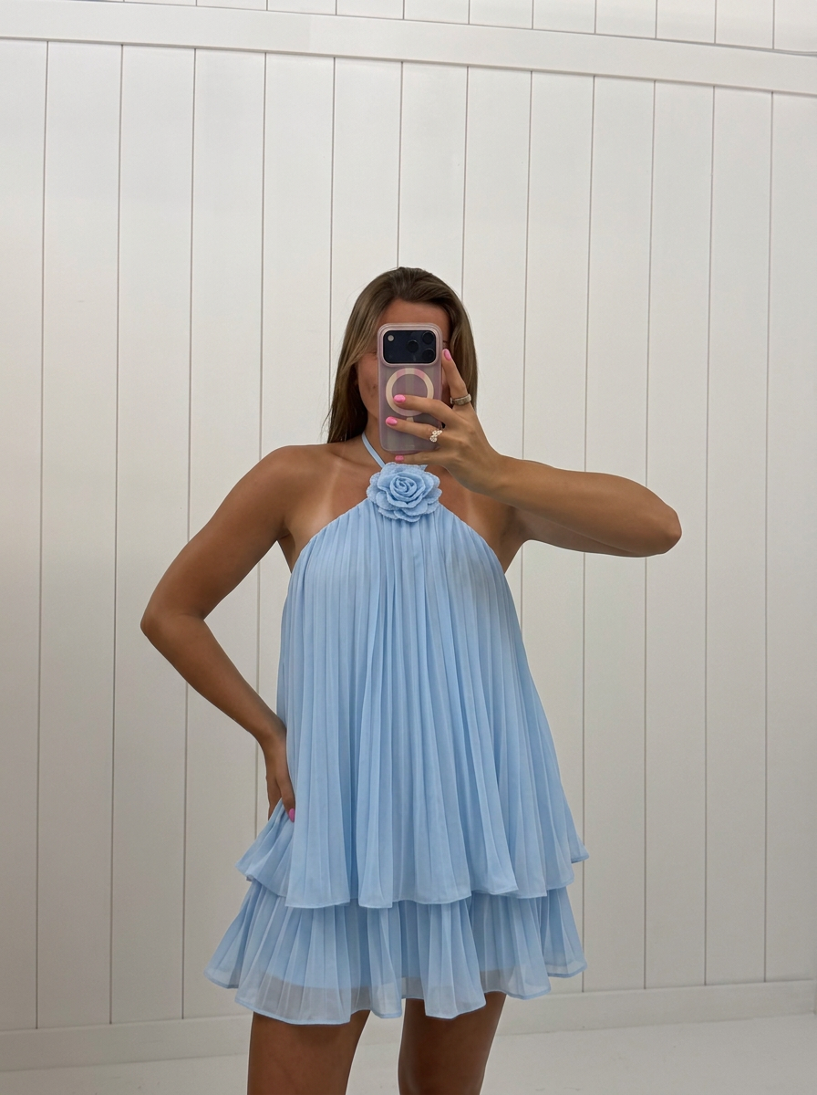 AI-assisted FASHN try-on of Light Blue Flower Pin Mini Dress on boutique owner.