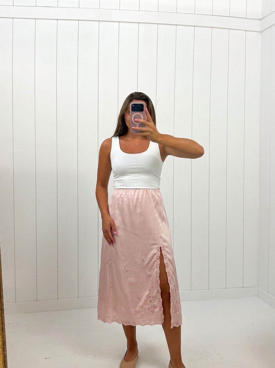AI-assisted FASHN try-on of Pink Satin Embroidered Midi Skirt on boutique owner.
