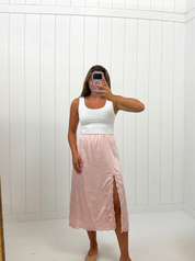 AI-assisted FASHN try-on of Pink Satin Embroidered Midi Skirt on boutique owner.