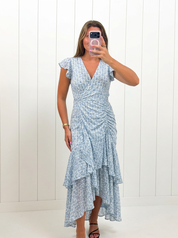 AI-assisted FASHN try-on of Blue Aria Maxi Dress on boutique owner.