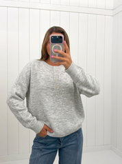 AI-assisted FASHN try-on of Gray Oversized Half Button Sweater on boutique owner.