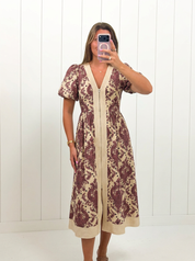 AI-assisted FASHN try-on of Cream & Burgundy Paisley Midi Dress on boutique owner.