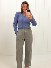 AI-assisted FASHN try-on of Matilda Gingham Pants on boutique owner.