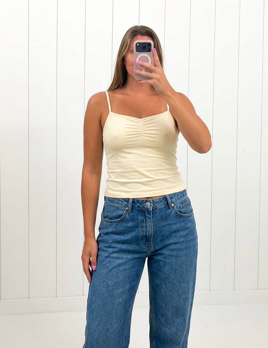 AI-assisted FASHN try-on of Yellow V-Neck Cami Top on boutique owner.