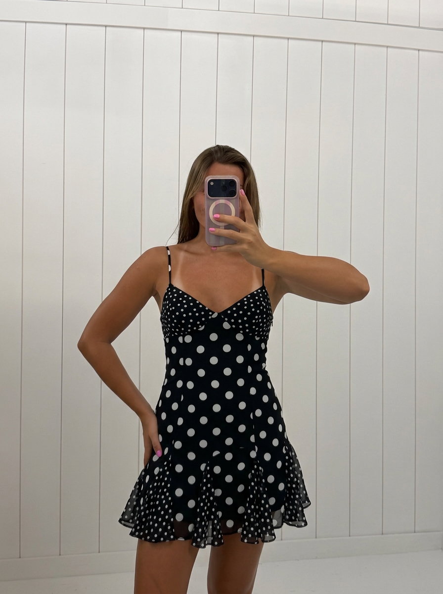 AI-assisted FASHN try-on of Black Polka Dot Mini Dress on boutique owner.