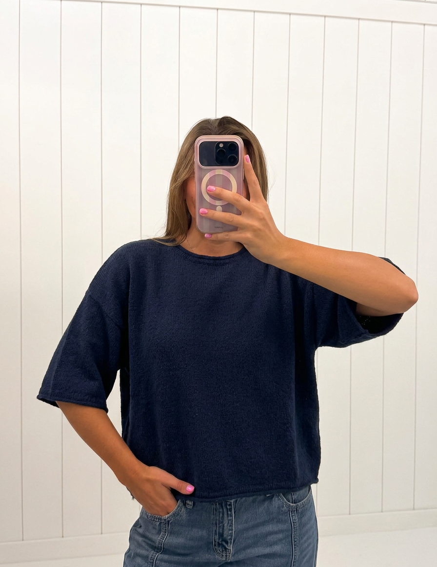 AI-assisted FASHN try-on of Navy Boxy Knit Sweater on boutique owner.