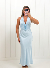 AI-assisted FASHN try-on of Light Blue Sleeveless Deep Halter Maxi Dress on boutique owner.